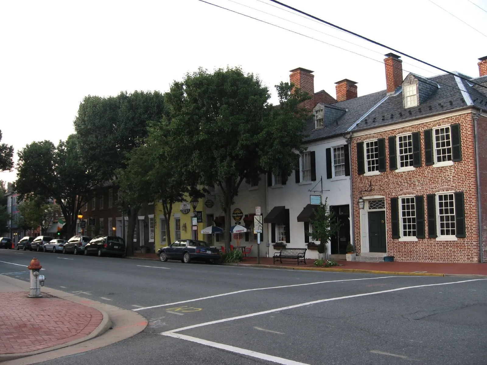 Caroline Street in historic downtown Fredericksburg, lined with brick storefronts.